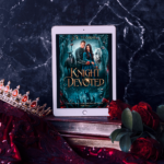 Cover of Knight Devoted on a Kindle in front of a marble wall, with a crown and roses in the foreground