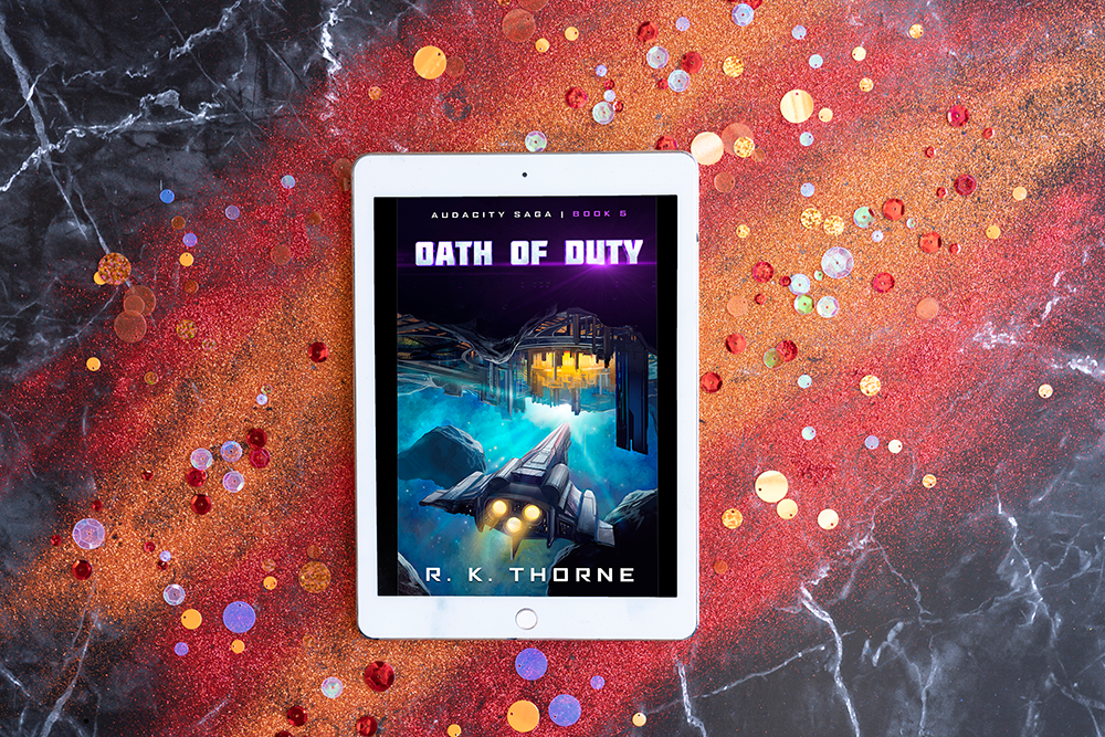 OATH OF DUTY kindle file on top of a orange and black background of colored sand and confetti over black marble