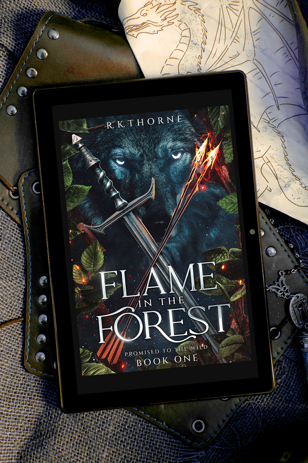 Flame in the Forest cover over leather armor and a drawing